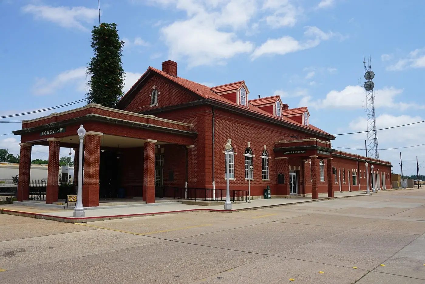 The red brick Longview Transportation Center train station with a covered platform